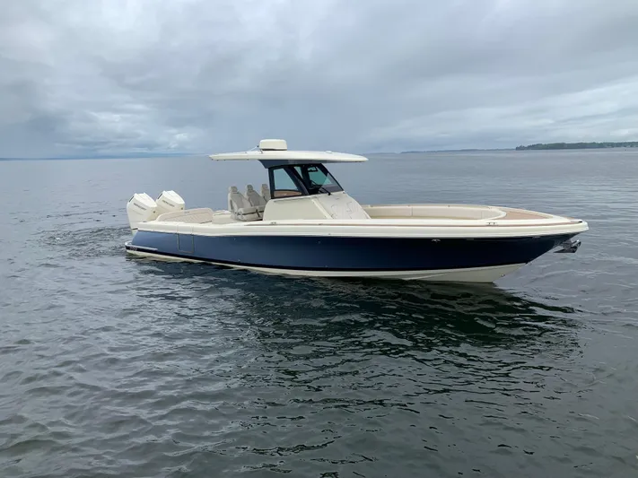  Yacht Photos Pics 2024 Chris-Craft Catalina 34 boat on calm water under cloudy sky.