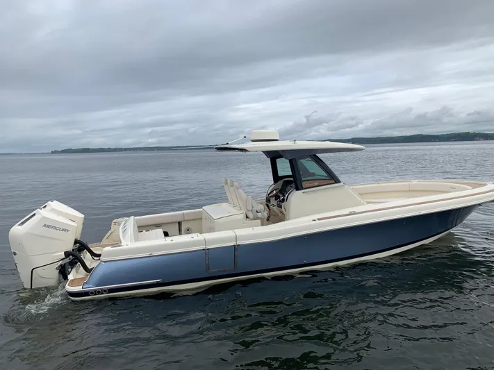  Yacht Photos Pics 2024 Chris-Craft Catalina 34 boat on calm water under cloudy sky.