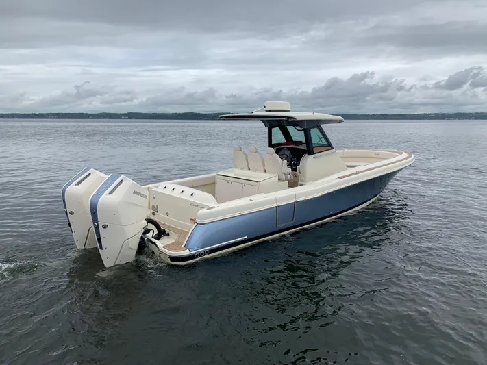  Yacht Photos Pics 2024 Chris-Craft Catalina 34 boat on calm water, featuring dual outboard engines.