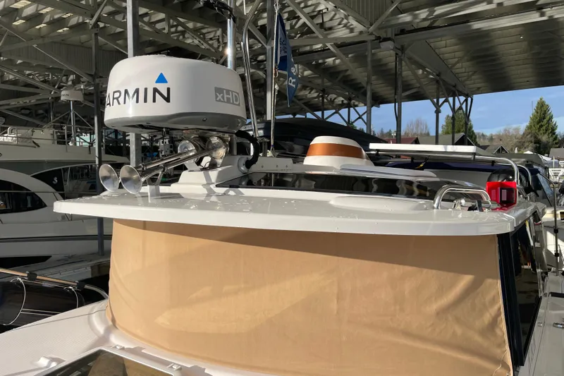  Yacht Photos Pics 2019 Ranger Tugs R-27 with Garmin xHD radar, docked under a covered marina.