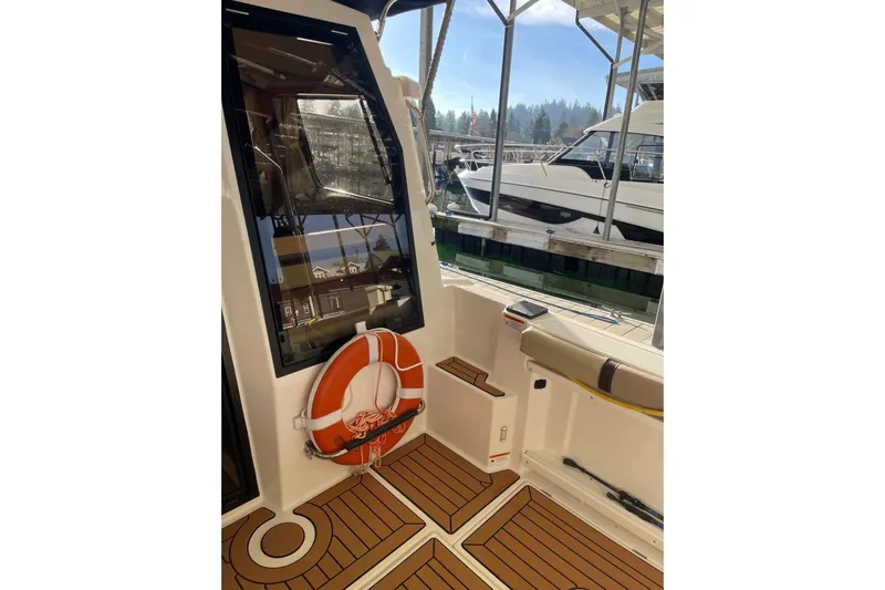  Yacht Photos Pics 2019 Ranger Tugs R-27 boat interior with life preserver and docked view.