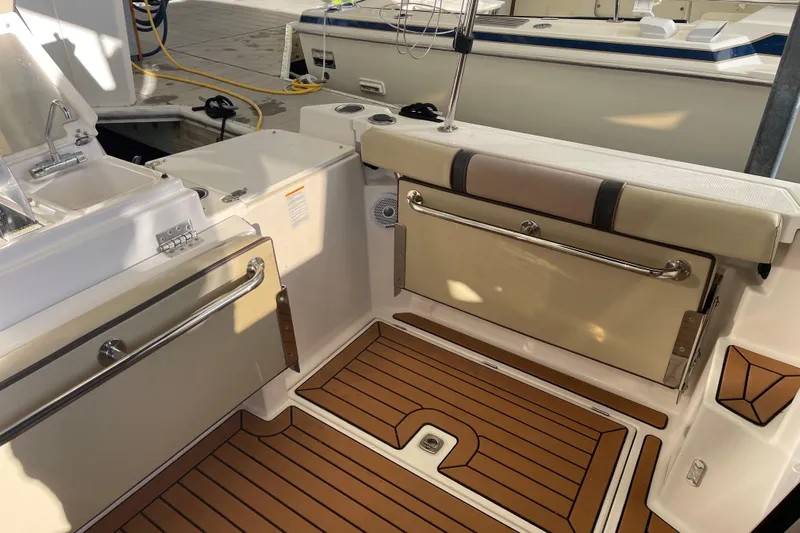  Yacht Photos Pics 2019 Ranger Tugs R-27 boat interior with teak flooring and seating area.