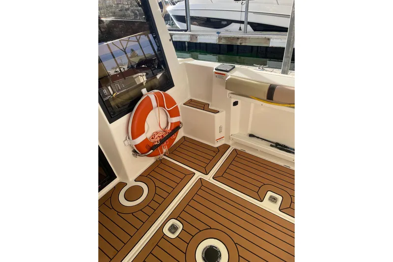  Yacht Photos Pics 2019 Ranger Tugs R-27 boat interior with teak flooring and life preserver.