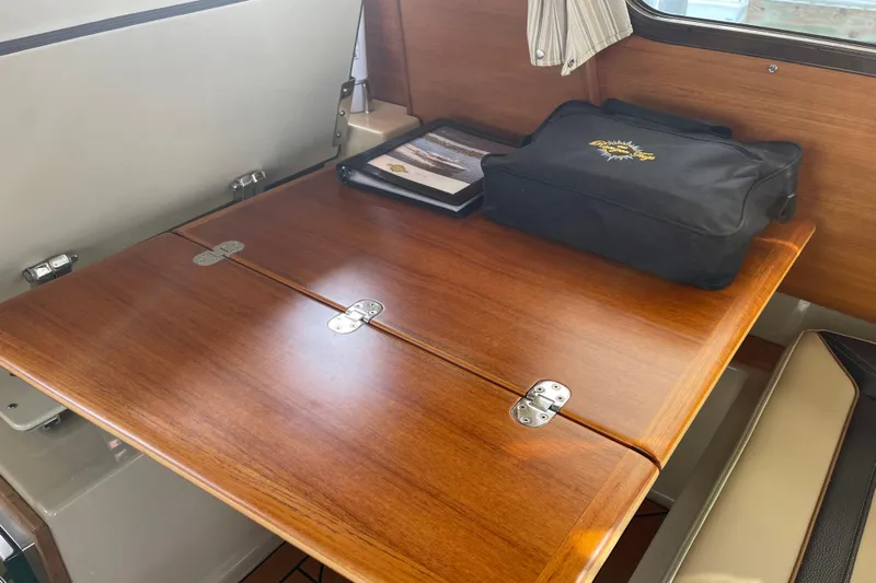  Yacht Photos Pics 2019 Ranger Tugs R-27 interior with wooden table and storage bag.