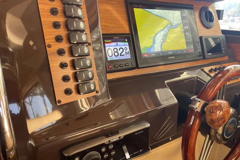  Yacht Photos Pics 2019 Ranger Tugs R-27 dashboard with navigation system and wooden steering wheel.