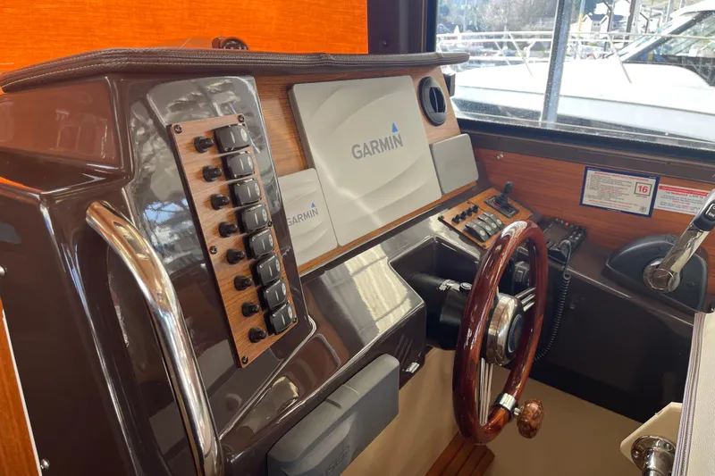  Yacht Photos Pics 2019 Ranger Tugs R-27 helm with Garmin navigation system and wooden steering wheel.