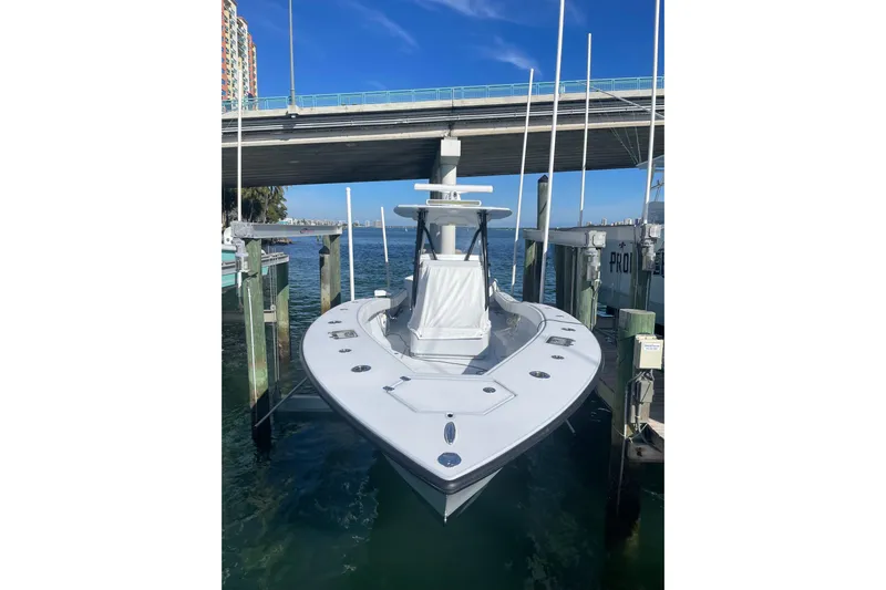  Yacht Photos Pics 2022 Conch 33 boat docked under a bridge on a sunny day.