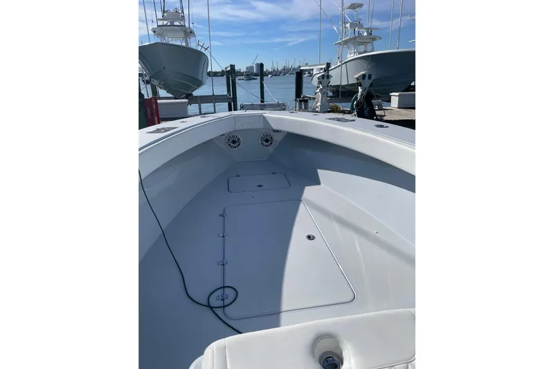  Yacht Photos Pics 2022 Conch 33 boat interior at dock, showcasing spacious deck and sleek design.
