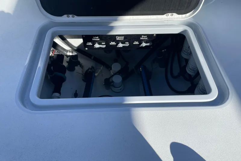  Yacht Photos Pics Open hatch of 2022 Conch 33 boat showing engine controls and components.