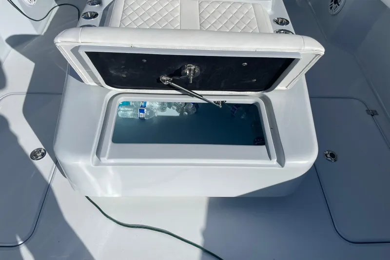  Yacht Photos Pics Open storage compartment on 2022 Conch 33 boat with water bottles inside.