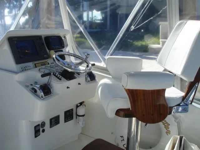 Bait's Factor Yacht Photos Pics Helm of 2002 Stolper 35 EXPRESS boat with steering wheel and navigation equipment.
