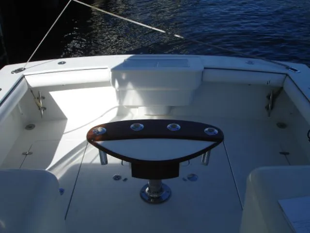 Bait's Factor Yacht Photos Pics 2002 Stolper 35 EXPRESS boat deck with fishing rod holders, docked by the water.