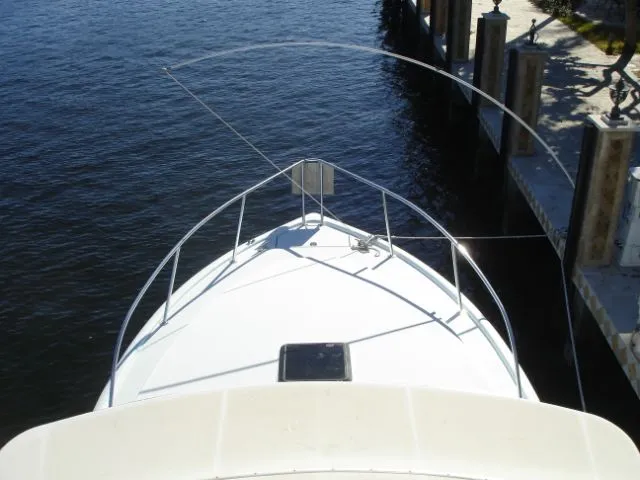 Bait's Factor Yacht Photos Pics Bow view of 2002 Stolper 35 EXPRESS boat docked by the water.