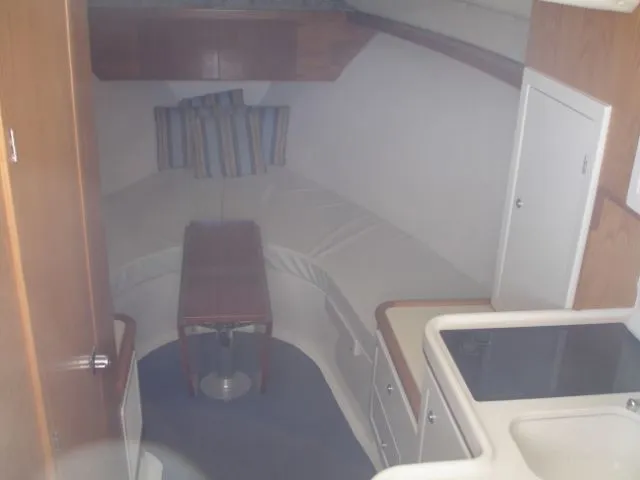 Bait's Factor Yacht Photos Pics Interior of 2002 Stolper 35 EXPRESS boat with seating, table, and kitchenette.