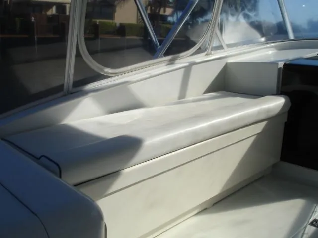 Bait's Factor Yacht Photos Pics 2002 Stolper 35 EXPRESS boat interior with cushioned seating and windows.