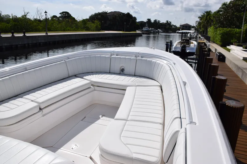  Yacht Photos Pics 2017 Intrepid 327 boat with white seating, docked in a serene canal setting.