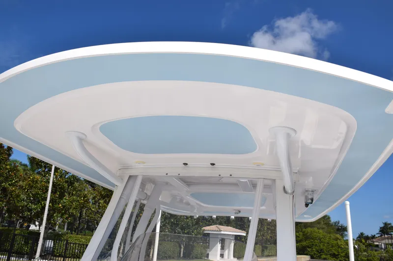  Yacht Photos Pics 2017 Intrepid 327 boat with sleek white and blue hardtop against a clear sky.