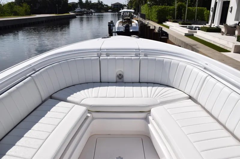  Yacht Photos Pics 2017 Intrepid 327 boat with white seating, docked by a canal.