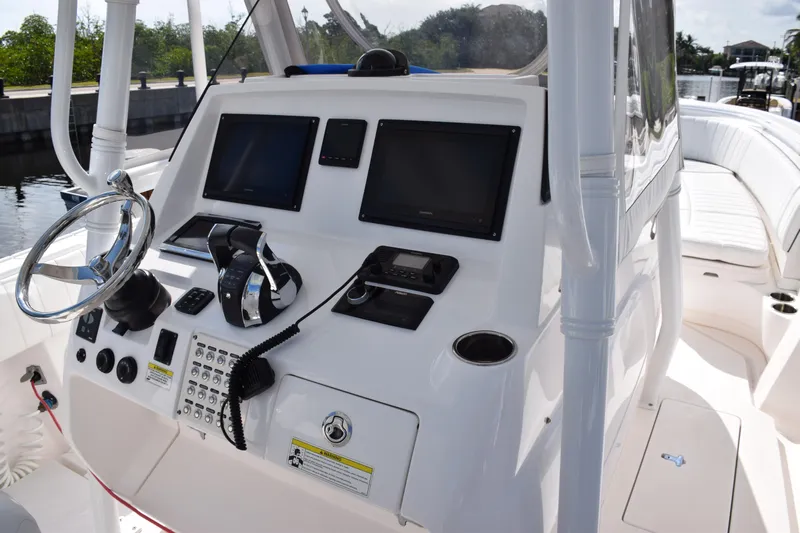  Yacht Photos Pics 2017 Intrepid 327 boat dashboard with steering wheel and navigation screens.
