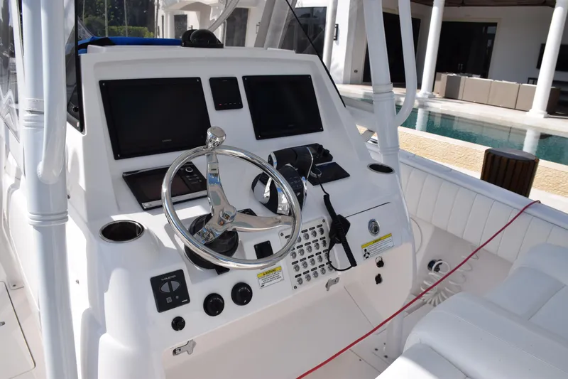  Yacht Photos Pics 2017 Intrepid 327 boat dashboard with steering wheel and control panels.
