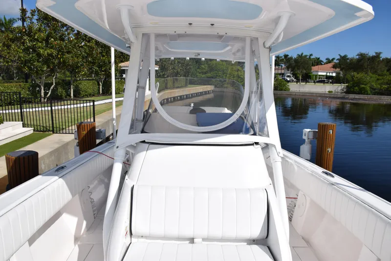  Yacht Photos Pics 2017 Intrepid 327 boat with white seating, docked by a serene canal.