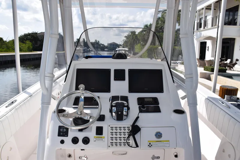  Yacht Photos Pics 2017 Intrepid 327 boat dashboard with steering wheel and navigation controls.