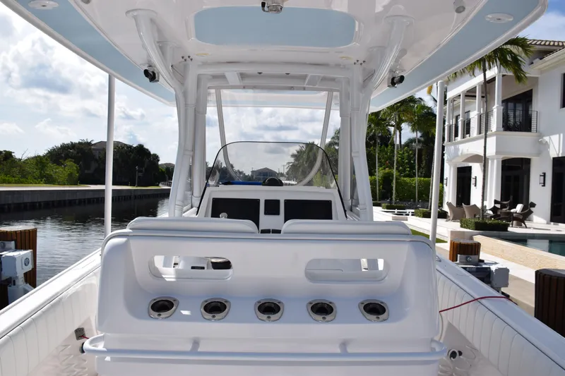  Yacht Photos Pics 2017 Intrepid 327 boat interior with rod holders, docked near luxury waterfront homes.