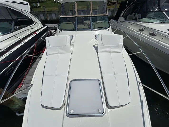  Yacht Photos Pics 2021 Formula 34 Performance Cruiser with white deck and sun loungers, docked at marina.