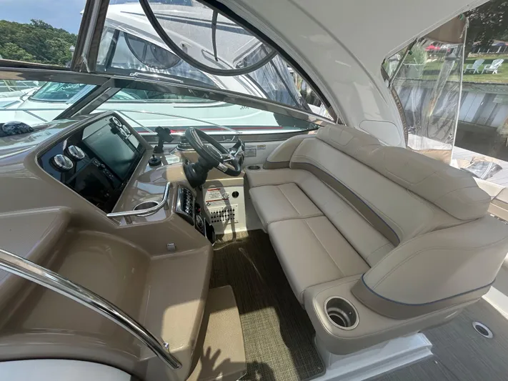  Yacht Photos Pics 2021 Formula 34 Performance Cruiser interior with beige seating and modern dashboard.