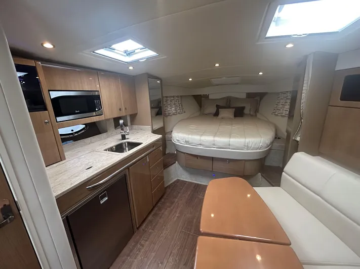  Yacht Photos Pics Interior of 2021 Formula 34 Performance Cruiser with kitchen, bed, and seating area.