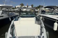 2023 Saxdor 270 GTO boat docked at a marina, surrounded by other vessels.