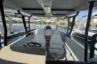 2023 Saxdor 270 GTO boat interior with white seating, docked at marina.
