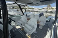 2023 Saxdor 270 GTO boat interior with luxurious seating at a marina.
