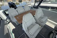 2023 Saxdor 270 GTO boat interior with plush seating and wooden table.