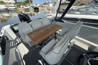 2023 Saxdor 270 GTO boat interior with seating and table, docked at marina.