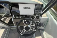 2023 Saxdor 270 GTO boat dashboard with Simrad display and steering wheel.