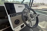 Steering wheel and dashboard of 2023 Saxdor 270 GTO boat with Simrad display.