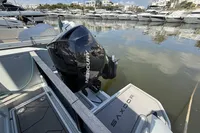 2023 Saxdor 270 GTO boat with Mercury engine docked in a marina.
