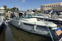 2023 Saxdor 270 GTO boat docked in a marina, surrounded by other vessels.