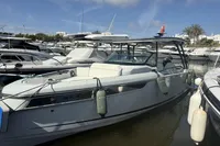 2023 Saxdor 270 GTO boat docked in a marina under a clear blue sky.