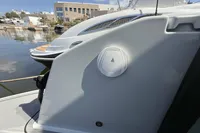 2023 Saxdor 270 GTO boat detail, docked in a marina under a clear sky.