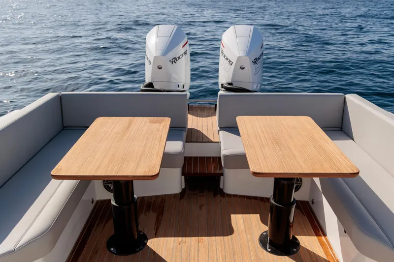 Rock Marine Rm 40 Yacht Photos Pics 2026 Rock Marine RM 40 boat with twin outboard engines and wooden deck tables.