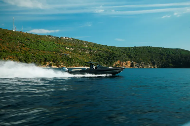 Rock Marine Rm 40 Yacht Photos Pics 2026 Rock Marine RM 40 speeding on blue water near lush green coastline.