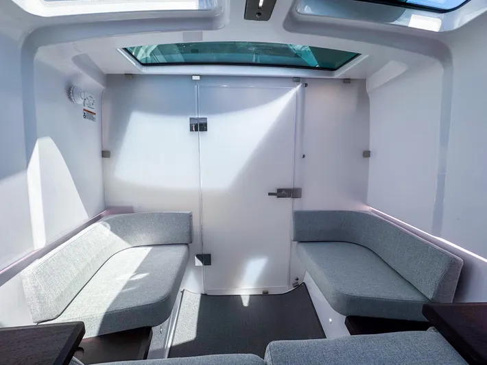  Yacht Photos Pics 2024 Axopar 37XC CROSS CABIN interior with skylight and gray seating.