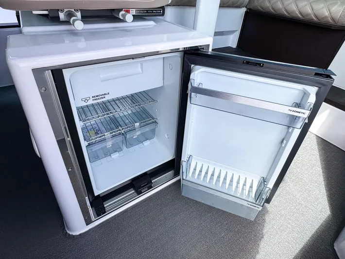  Yacht Photos Pics Open refrigerator inside 2024 Axopar 37XC CROSS CABIN boat, showcasing interior storage space.