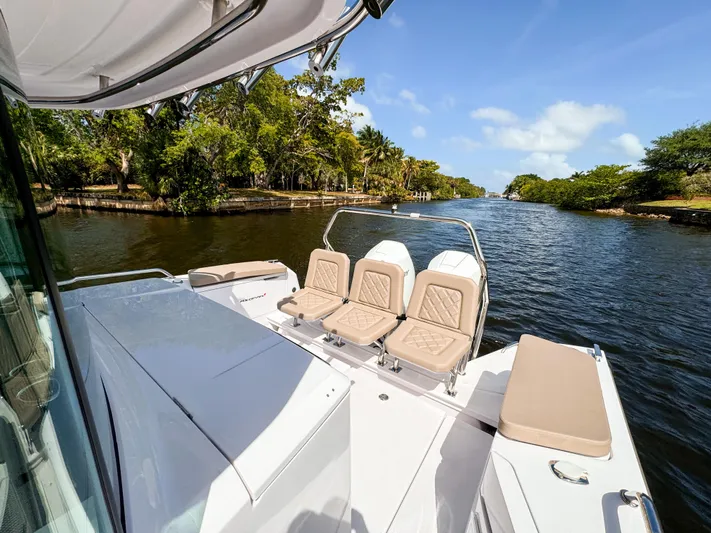  Yacht Photos Pics 2024 Axopar 37XC CROSS CABIN on scenic river with lush greenery.