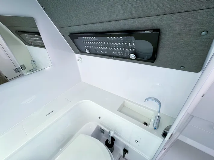  Yacht Photos Pics 2024 Axopar 37XC CROSS CABIN bathroom with modern sink and control panel.