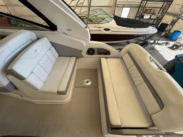  Yacht Photos Pics 2021 Regal 2800 Express boat interior with white seating in a storage facility.