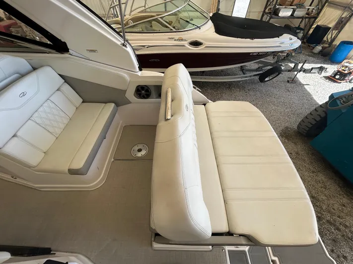  Yacht Photos Pics 2021 Regal 2800 Express boat interior with white seating in a garage setting.