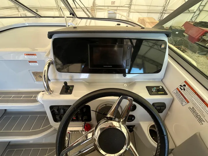  Yacht Photos Pics 2021 Regal 2800 Express boat helm with steering wheel and control panel.